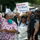 Marchers walk through the Homewood neighborhood during their Black Brilliance Collective: March and Gathering on Aug. 19, 2017, in Pittsburgh.